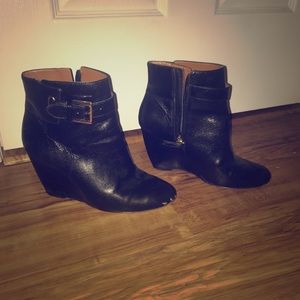 Black booties with gold buckles